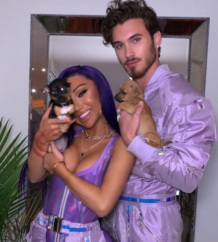 YouTuber Nikita Dragun and her ex-boyfriend Michael Yerger both in purple holding puppies.